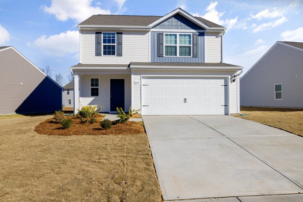 White and Blue House Under Blue Sky fix by Garage Door Repair Westborough, MA